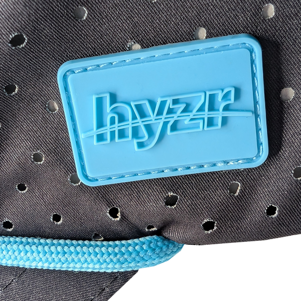 Closeup of the Hyzr logo on a mint rubber patch.