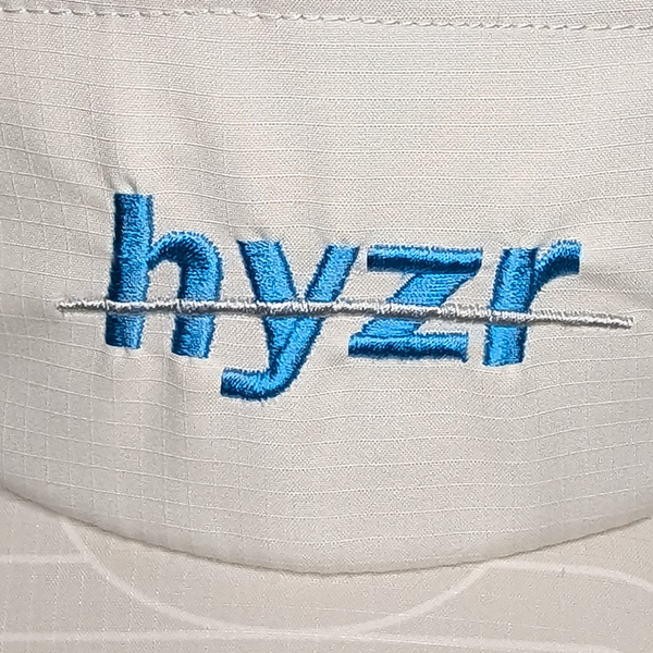 Closeup of the Hyzr logo embroidered in electric blue.