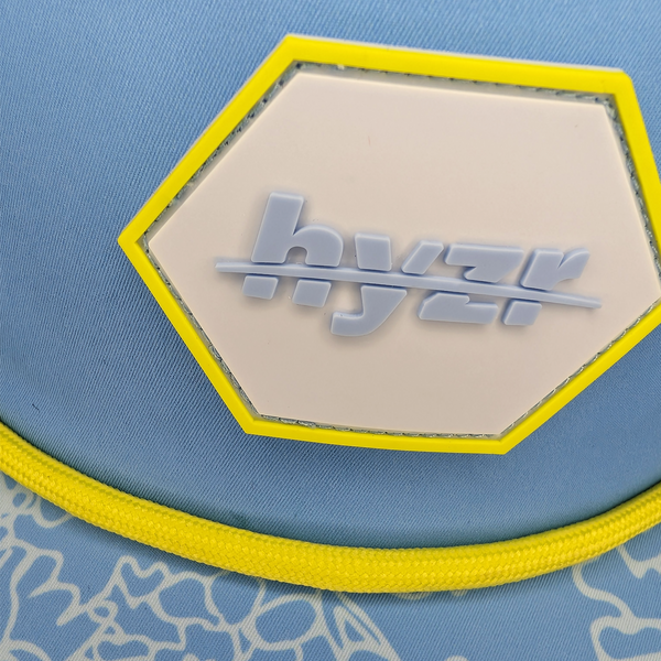Closeup of the Hyzr logo on a hexagon rubber patch.