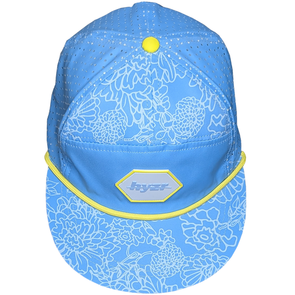 Top view of the Cordelia Deck Hat. Powder blue 7-panel flat brimmed hat, with a floral print and a yellow rope.